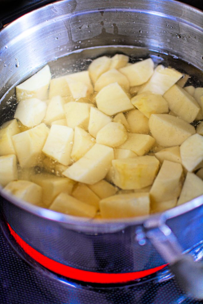 peeled potatoes cooking on stovetop